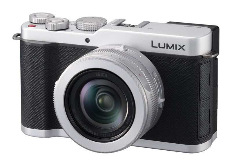 A silver and black Lumix digital camera with a Leica lens is shown from a front-facing angle against a white background.