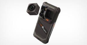 A rugged, dark gray smartphone with a modular camera attachment floating above its back panel, which features a "Rugone" logo.
