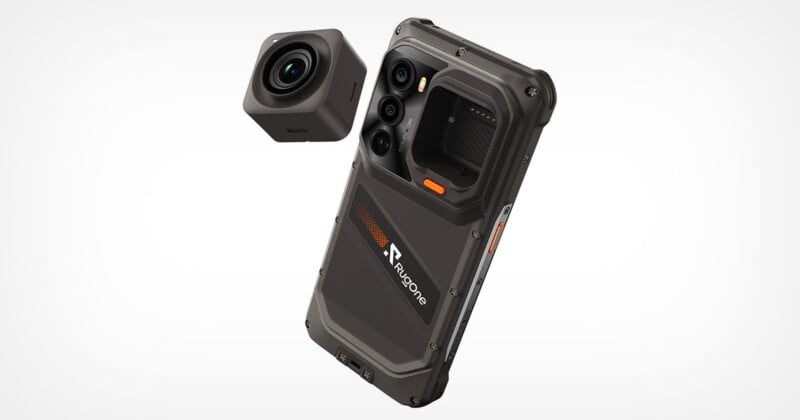 A rugged, dark gray smartphone with a modular camera attachment floating above its back panel, which features a "Rugone" logo.
