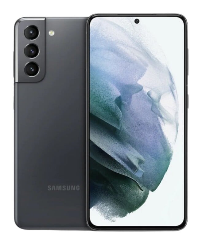 A dark gray Samsung smartphone shown from both the front and back, featuring a triple-lens camera module and a screen displaying an abstract blue and white wallpaper.
