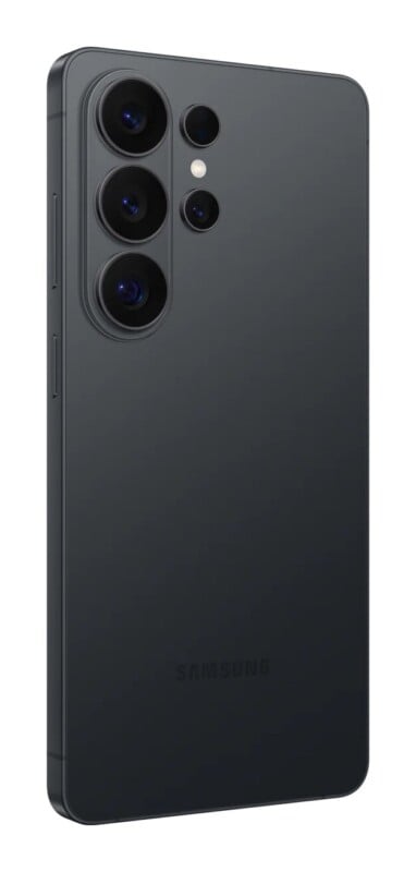 A dark gray smartphone shown from a rear three-quarter angle, featuring a vertical triple-camera array and the Samsung logo at the bottom.
