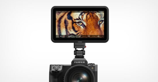 A Fujifilm camera with an attached Atomos external monitor displaying a close-up image of a tiger's eye.