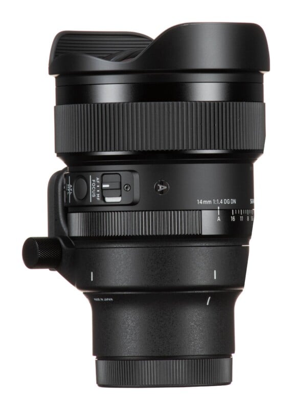 A black camera lens with a wide-angle front element, a focus ring, an aperture ring, and a focus mode switch labeled "AF" and "MF," standing vertically against a white background.