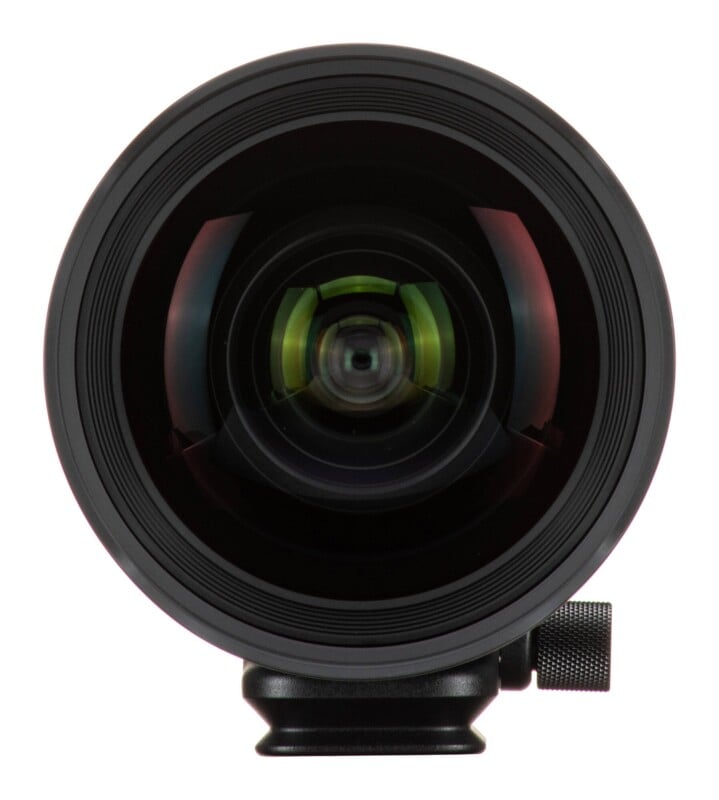 A front-facing view of a camera lens with a prominent, rounded glass element and a black mounting base with a knurled adjustment knob.