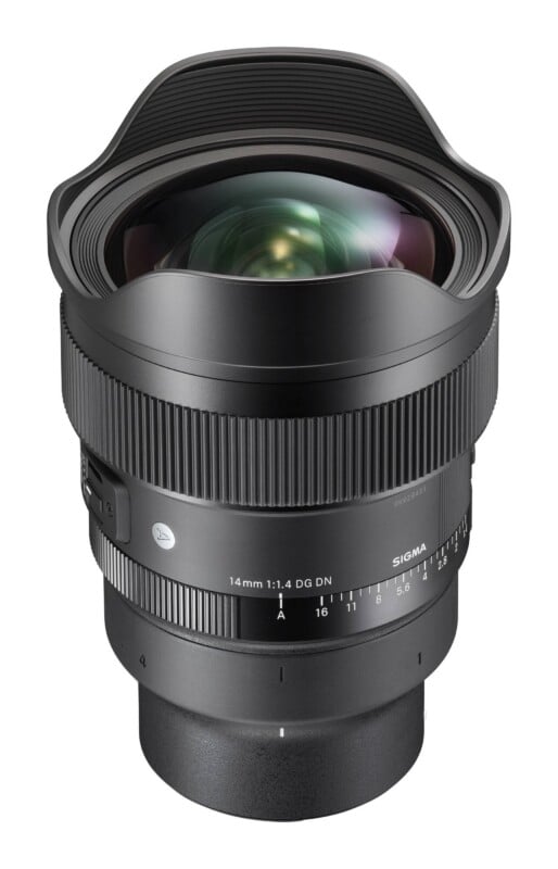 A black Sigma 14mm 1:1.4 DG DN camera lens stands vertically against a white background, featuring a wide front element, a ridged focus ring, and an aperture ring marked with settings from A to 16.