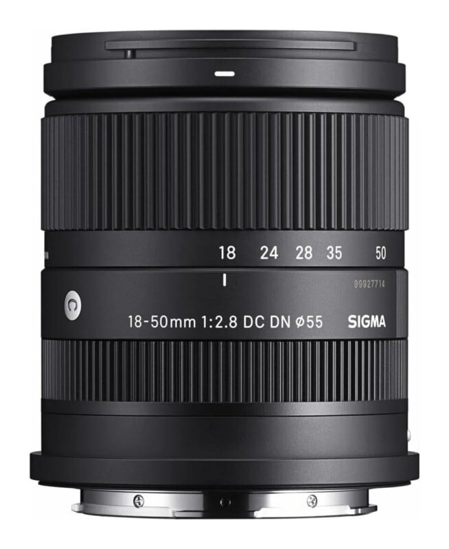 A black Sigma 18-50mm f/2.8 DC DN camera lens with a 55mm filter thread, shown from the side against a white background.