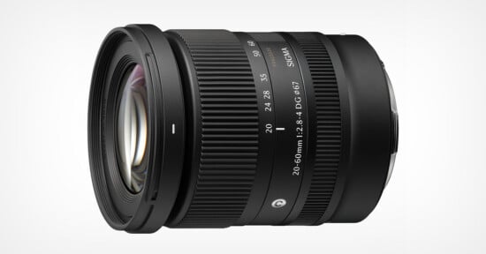 A black Sigma 20-60mm f/2.8-4 DG lens for mirrorless cameras, shown from a side angle against a white background.
