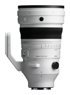 A white telephoto camera lens with a black focus ring, a tripod mount, and text reading "200mm 1:2 DG Ø105 SIGMA" on the side.