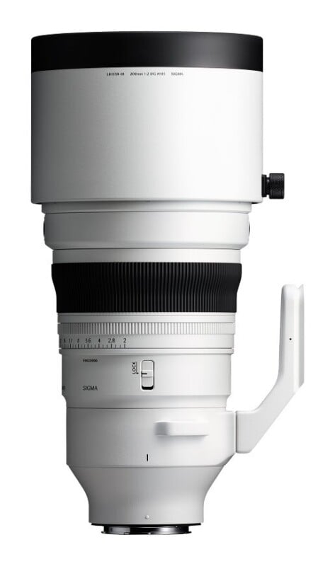 A white telephoto camera lens with a black focus ring and a tripod mount, shown against a white background.