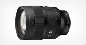 A black Sigma 85mm f/1.2 DG lens viewed from the side, featuring a focus ring, aperture ring, and an autofocus switch against a white background.