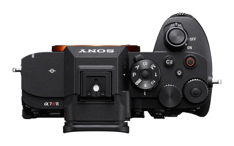 Top-down view of a black Sony Alpha 7R V mirrorless camera body showing the mode dial, shutter button, and various control buttons.