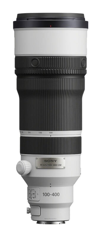 A white and black Sony FE 100-400mm GM telephoto zoom lens standing vertically against a white background.