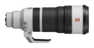A white and black telephoto zoom lens with a tripod mount, a G-Master logo, and a zoom smoothness adjustment switch.