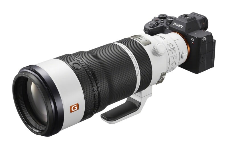 A Sony Alpha 7R camera body attached to a white Sony FE 100-400mm G Master telephoto zoom lens, isolated against a white background.