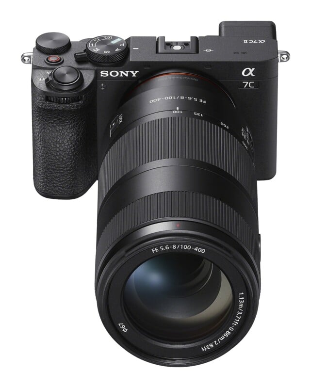 A black Sony Alpha 7C II mirrorless camera with a long telephoto zoom lens attached, viewed from a high angle against a white background.