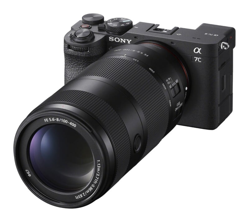 A black Sony Alpha 7C II mirrorless camera with a 100-400mm zoom lens attached, viewed from a front-right angle against a white background.