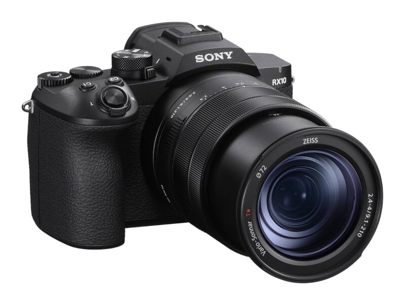 A black Sony RX10 digital camera with a large Zeiss Vario-Sonnar T* lens, shown from a front-right angle against a white background.