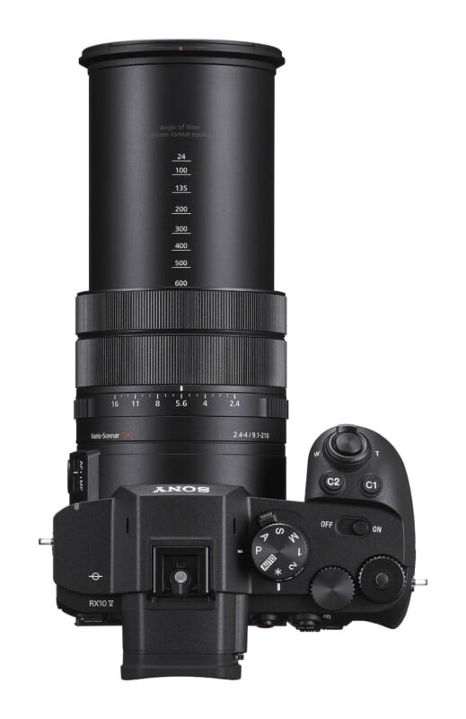 A top-down view of a black Sony RX10 V digital camera with an extended zoom lens showing focal length markings from 24 to 600.