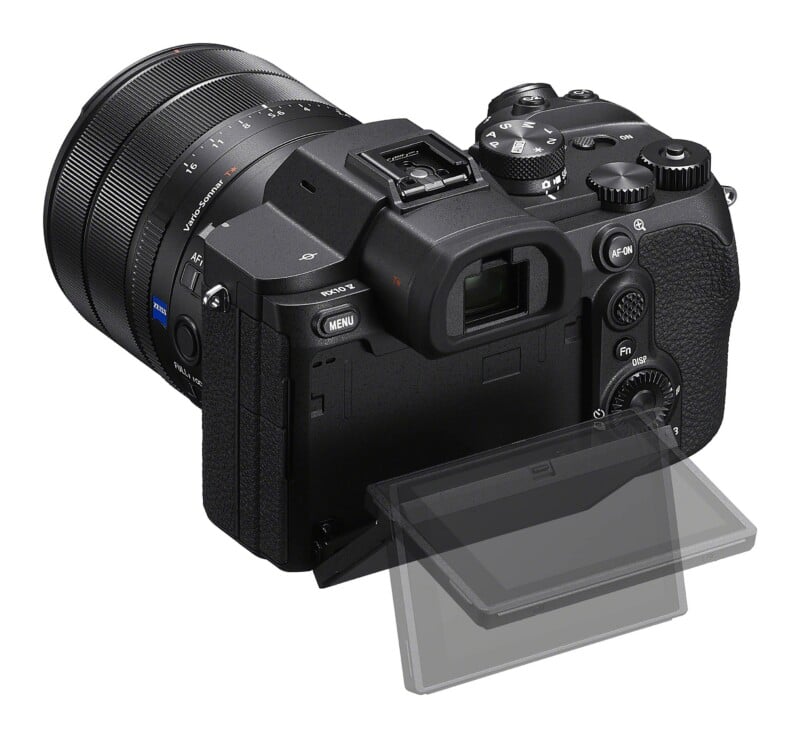 A black digital camera viewed from the rear, featuring a Zeiss Vario-Sonnar lens, a mode dial, and a partially tilted LCD screen.