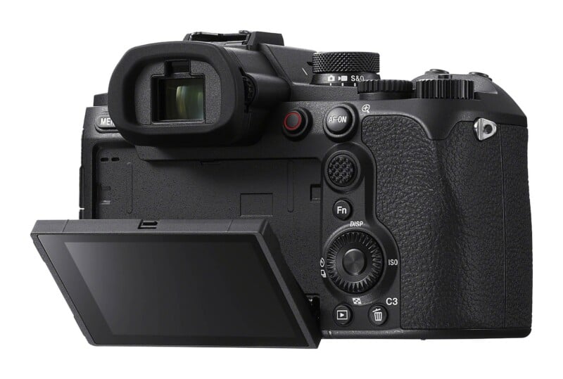 A black mirrorless camera viewed from the back, featuring an electronic viewfinder, a flip-out LCD screen, and various control buttons and dials.
