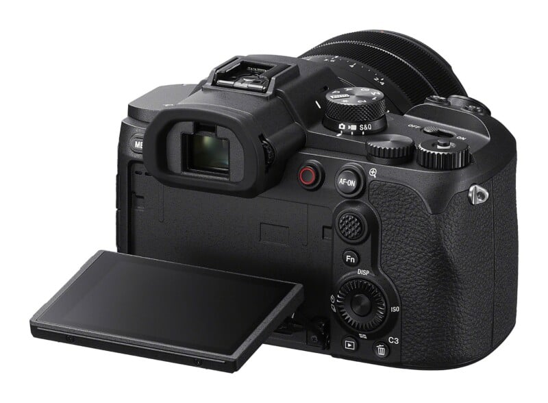 A black mirrorless camera viewed from the rear, featuring an electronic viewfinder, a mode dial, a record button, an AF-ON button, and a flip-out LCD screen.