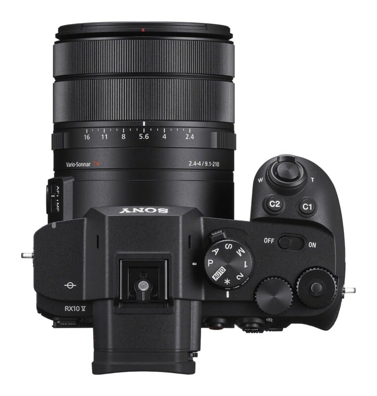 Top-down view of a black Sony RX10 V digital camera with a large zoom lens, showing the mode dial, shutter button, and various control buttons.