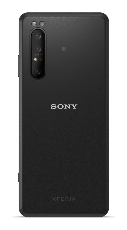 The back of a black Sony Xperia smartphone featuring a vertical triple-lens camera module with Zeiss branding and an NFC logo.