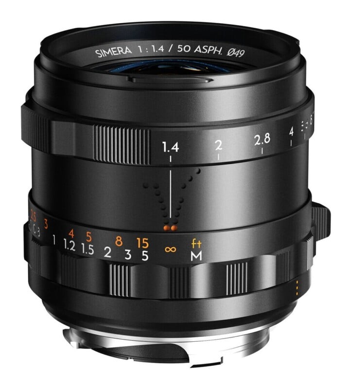 A black manual focus camera lens with aperture markings from 1.4 to 8 and distance scales in feet and meters.