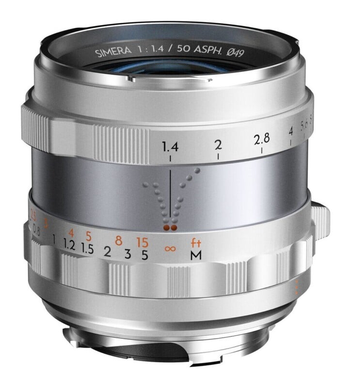 A silver camera lens with a 50mm focal length and f/1.4 aperture, featuring manual focus and aperture rings with visible distance and f-stop markings.