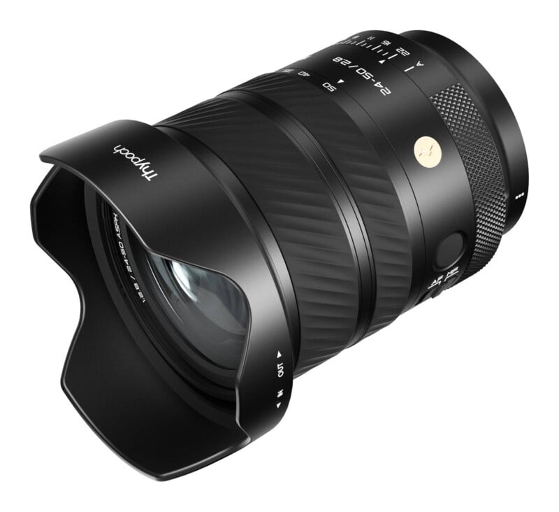 A black Thypoch 24-50/2.8 ASPH camera lens with a lens hood attached, viewed from a high angle against a white background.