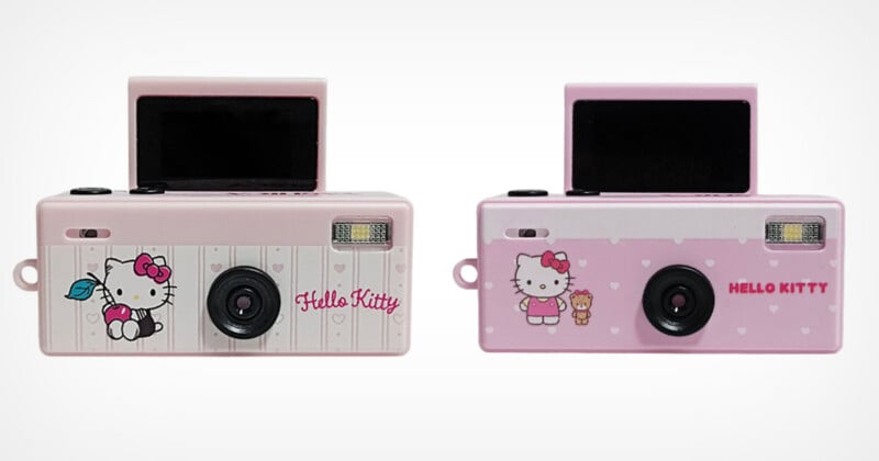 Two pink Hello Kitty digital cameras are shown side-by-side against a white background, both featuring a small pop-up screen and a front-facing lens.