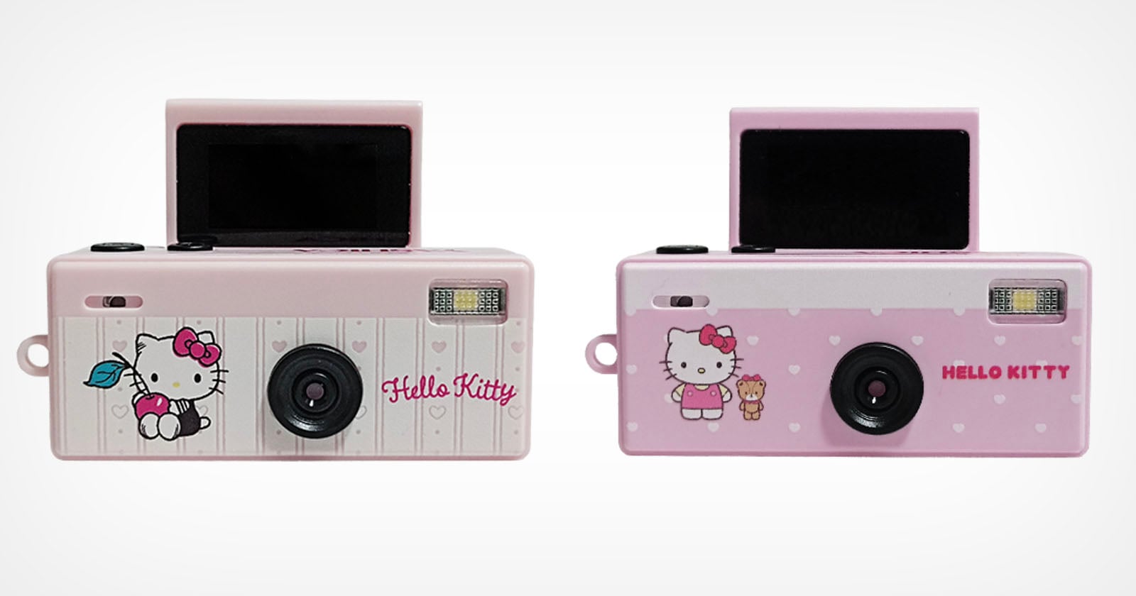 Two pink Hello Kitty digital cameras are shown side-by-side against a white background, both featuring a small pop-up screen and a front-facing lens.