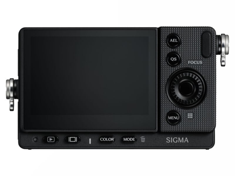 The back of a black digital camera featuring a large LCD screen, a circular navigation dial, and various control buttons labeled AEL, QS, FOCUS, MENU, COLOR, and MODE, with the word SIGMA printed on the bottom right.