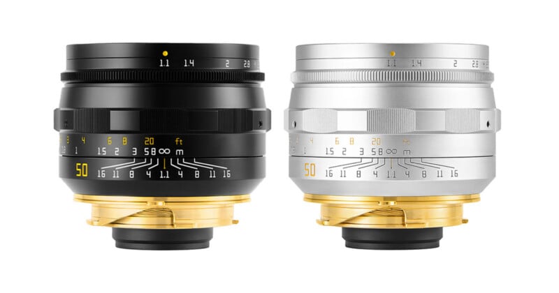 Two camera lenses, one black and one silver, are shown side-by-side against a white background, both featuring gold-colored mounts.