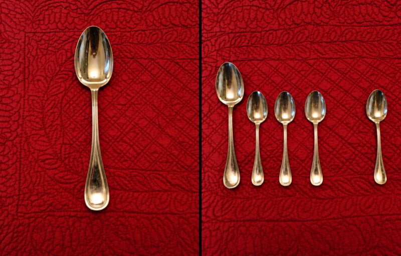 A large silver spoon is shown on the left, while five smaller silver spoons are arranged in a row on the right, all against a red quilted background.