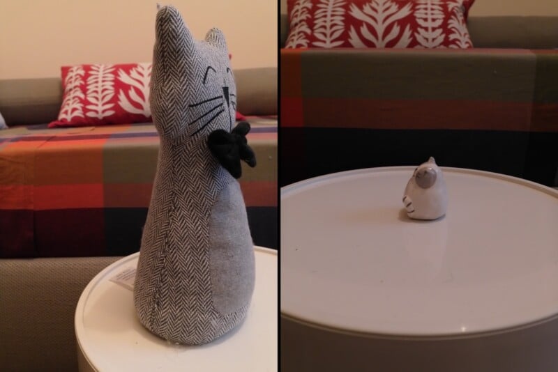 A split-screen view shows a large, grey herringbone fabric cat doorstop on the left and a tiny, white ceramic cat figurine on the right, both sitting on a white table.