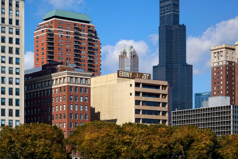 A view of several tall buildings in a city skyline, including a prominent sign reading "EBONY" and "JET" atop a tan building.