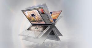 A transparent laptop with visible internal circuitry is shown in an exploded, multi-angled view against a light, abstract background.