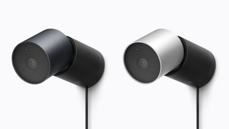 Two cylindrical security cameras are mounted side-by-side against a white background, one in dark gray and the other in silver.