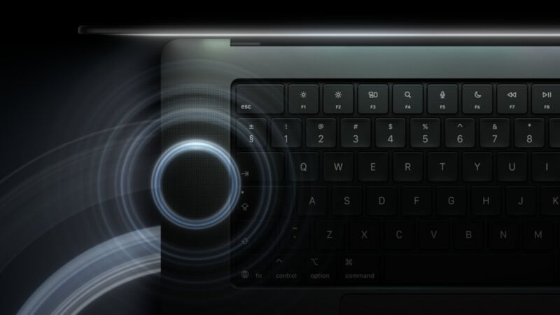 A close-up view of a dark laptop keyboard with a glowing, circular sound wave graphic emanating from the speaker grille on the left side.