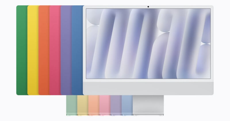 An Apple iMac computer is displayed in front of a row of its various color options, with a matching set of smaller color swatches arranged below.