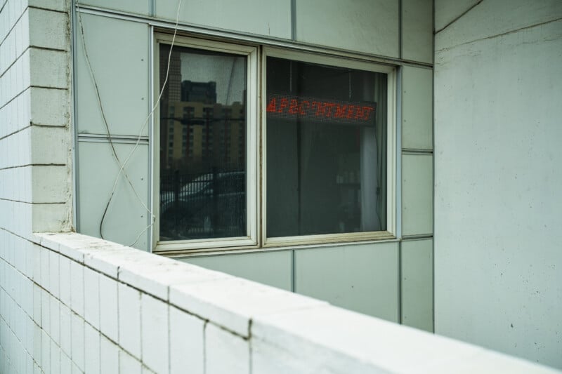 A window with a red LED sign reading 