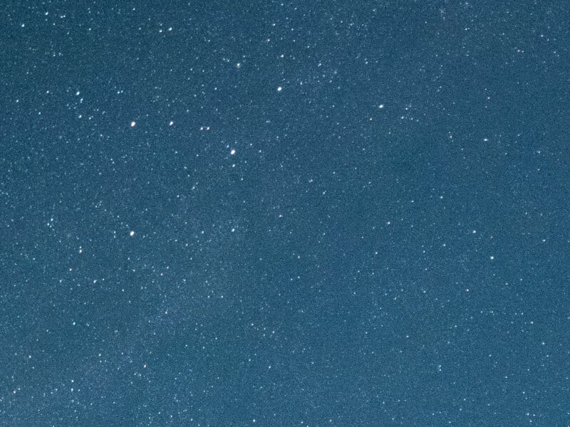 A dense field of stars scattered across a dark blue night sky.