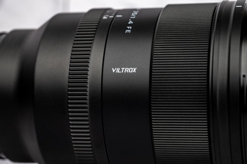 A close-up view of a black camera lens barrel featuring the brand name Viltrox and the text 35/1.4 FE printed on its side.