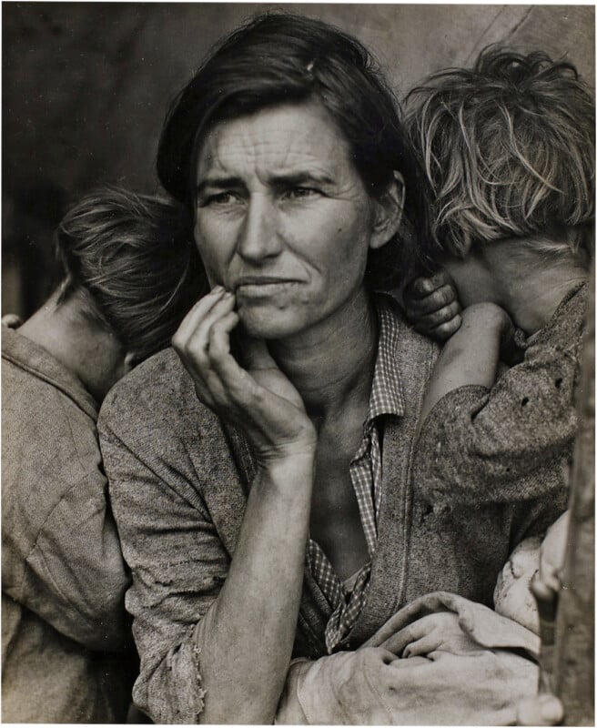 A woman with a worried expression rests her chin on her hand, flanked by two children who have their heads turned away from the camera.