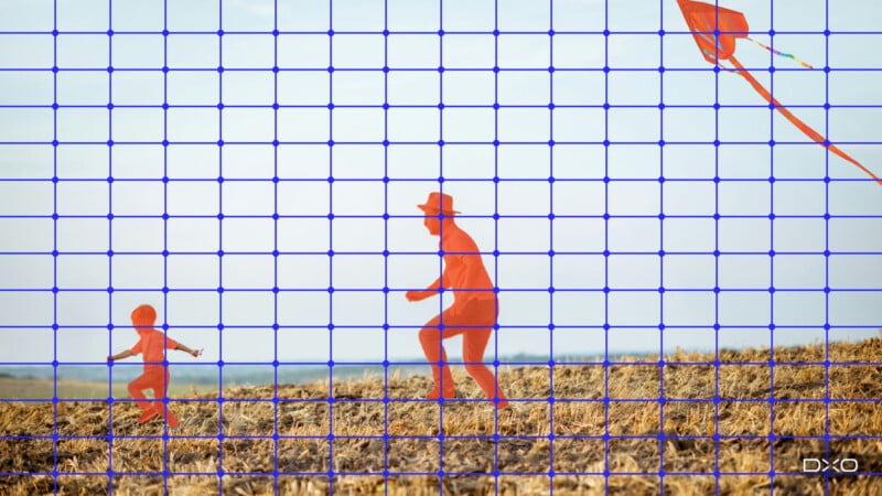 A child and an adult wearing a hat run through a field while flying a kite against a clear sky, overlaid with a blue grid.