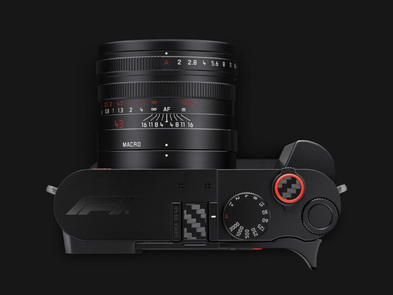 Top-down view of a black Leica Q3 43 camera featuring an F1 logo, carbon fiber accents, and a fixed lens with aperture and focus distance markings.