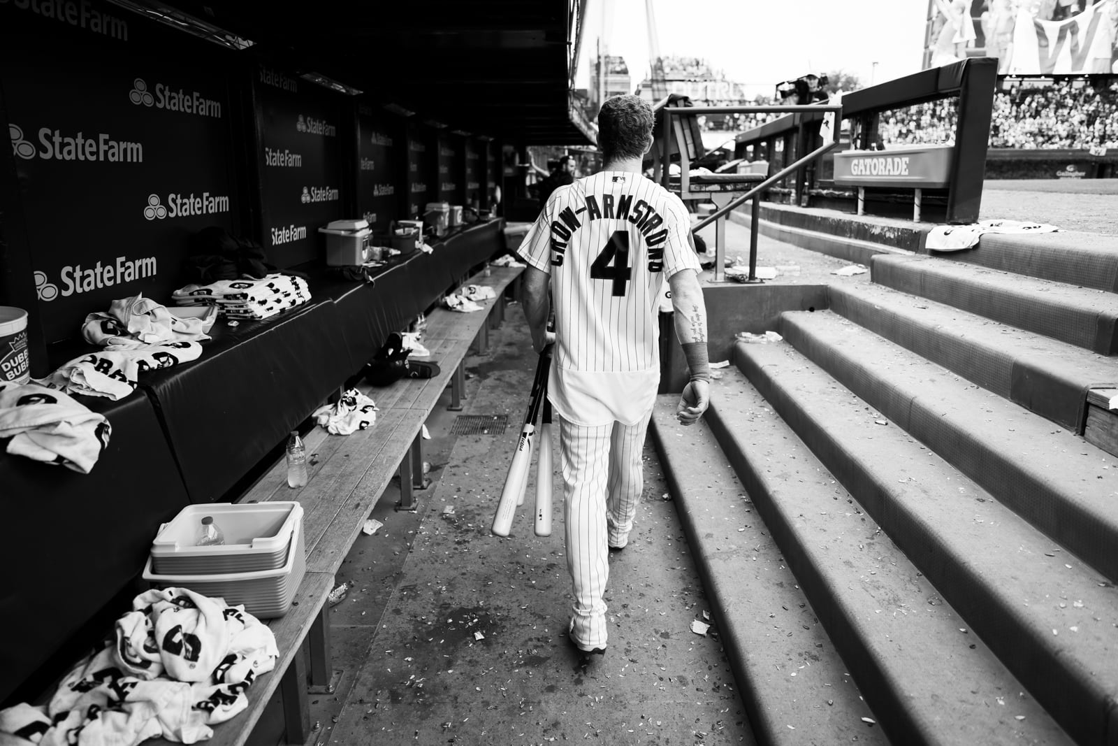A baseball player wearing a pinstriped jersey with the name CROW-ARMSTRONG and number 4 walks away from the camera through a dugout.