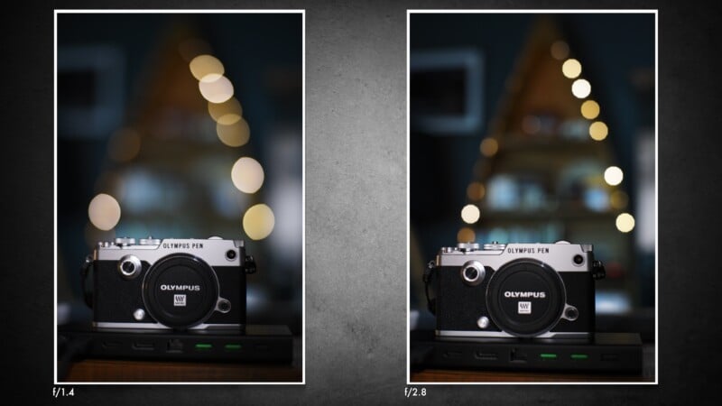 Two side-by-side photos of an Olympus Pen camera on a desk, showing the difference in background bokeh at f/1.4 and f/2.8 apertures.