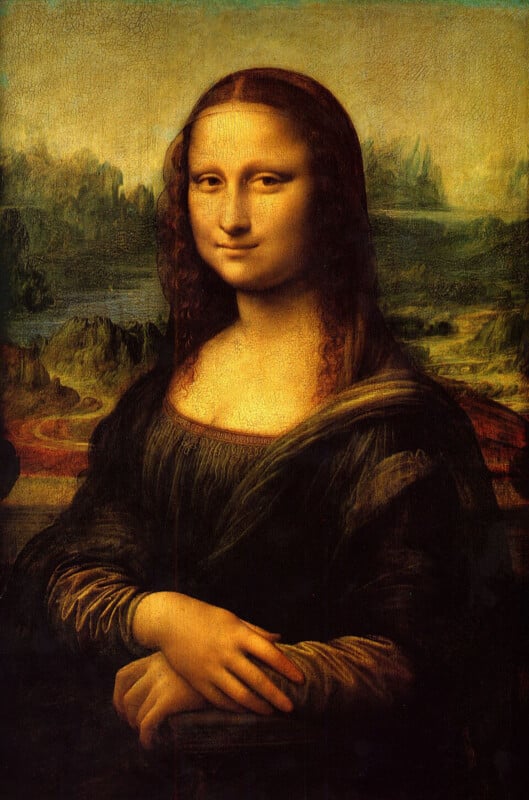 A portrait of a woman with long brown hair and a subtle smile, wearing a dark dress, seated before a distant landscape.